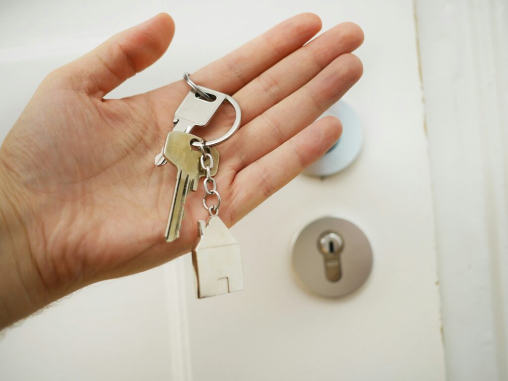 a hand with a home key